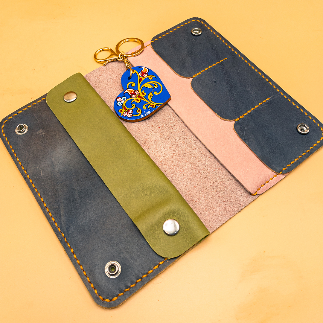 women's leather wallet accompanied by a blue wooden key ring decorated with Moorish floral patterns