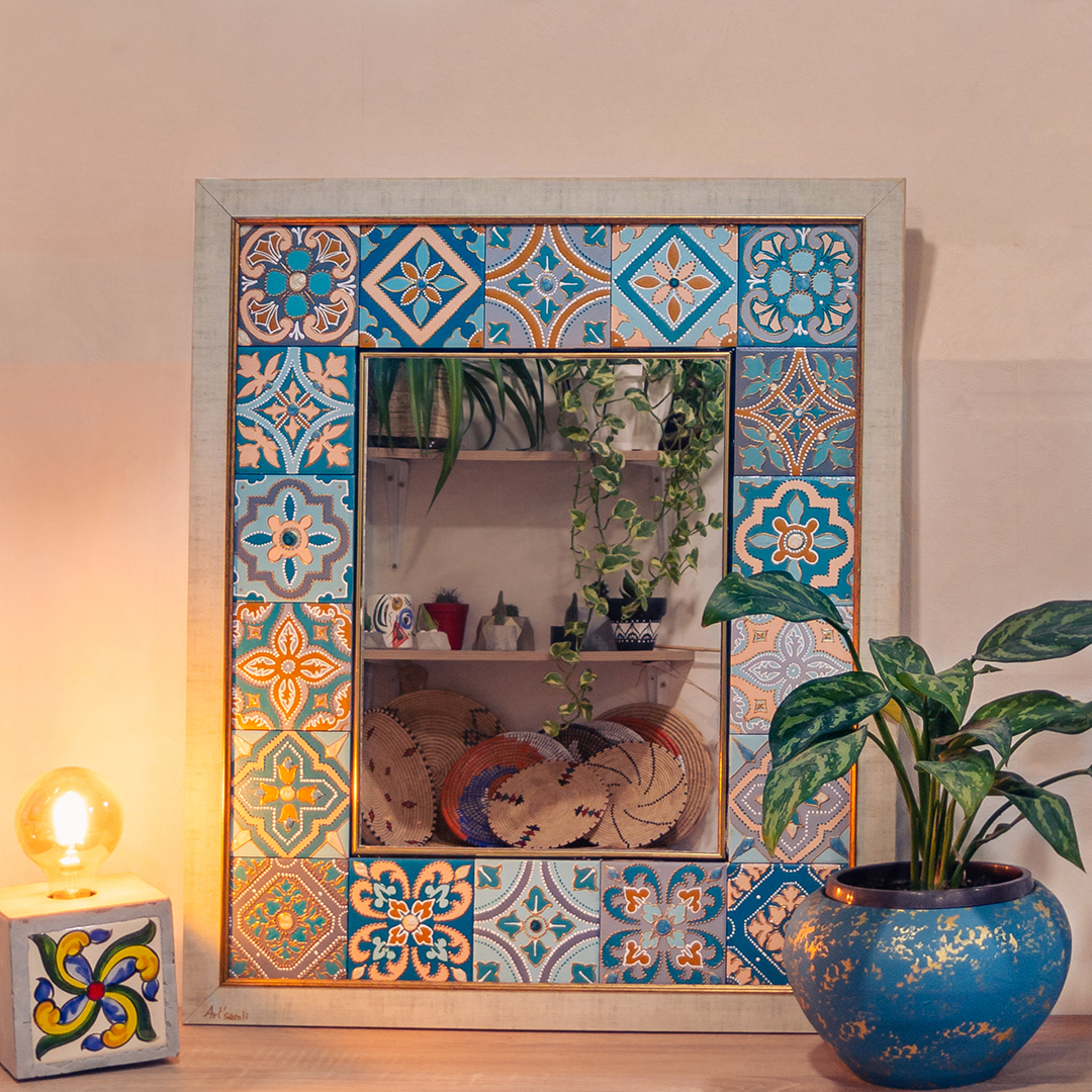 neo-Moorish style ceramic tile mirror, a plant in a blue terracotta pot, and a cubic lamp decorated with a zelidj tile